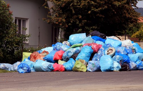 Recycling crew sorting items at curbside with labelled bags